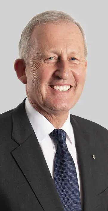 A headshot of BSL Board Chair Stephen Newton AO. He is wearing a charcoal suit and navy blue tie on white dress shirt.