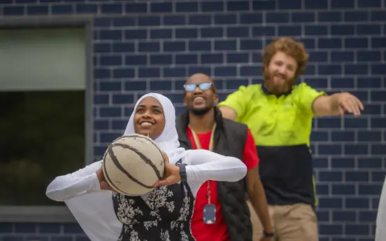 Left to right: Chaltu, Blaise and Jayden enjoy a game of basketball at our Broadmeadows Youth Foyer
