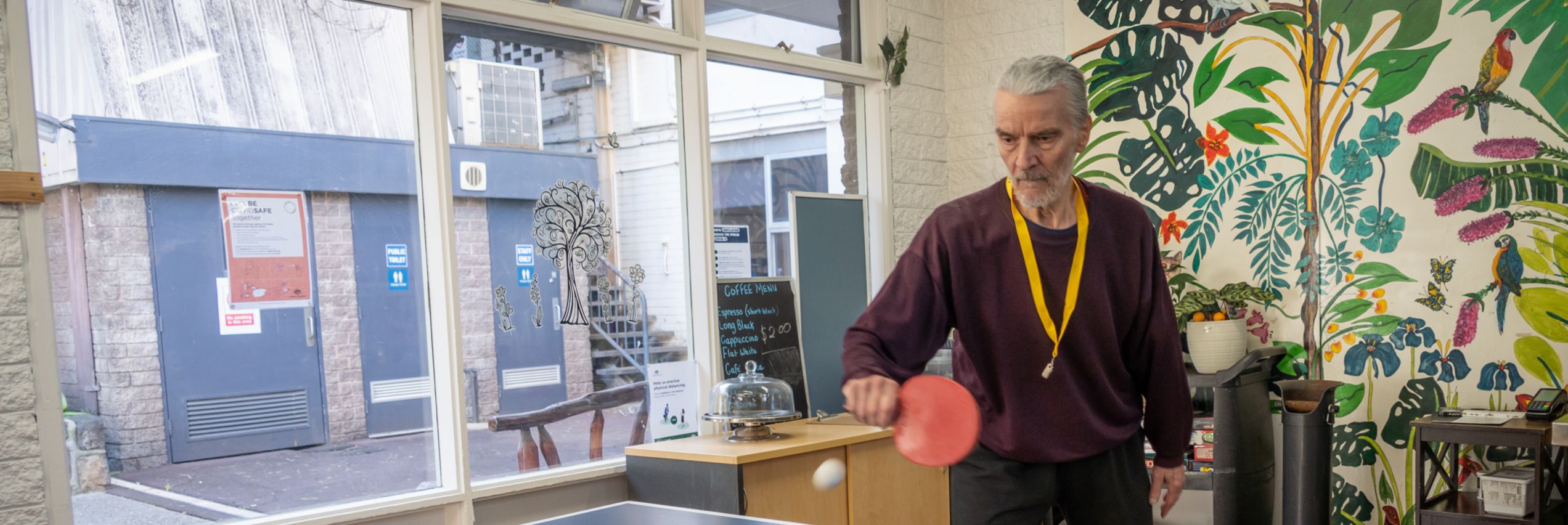 Jurgen Rogowsky, playing ping pong and about to hit the ball at the BSL Coolibah Centre.