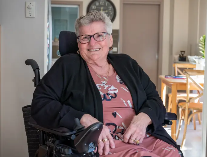 Shirley, a BSL home care client in Frankston, is sitting in a wheelchair smiling at the camera. 