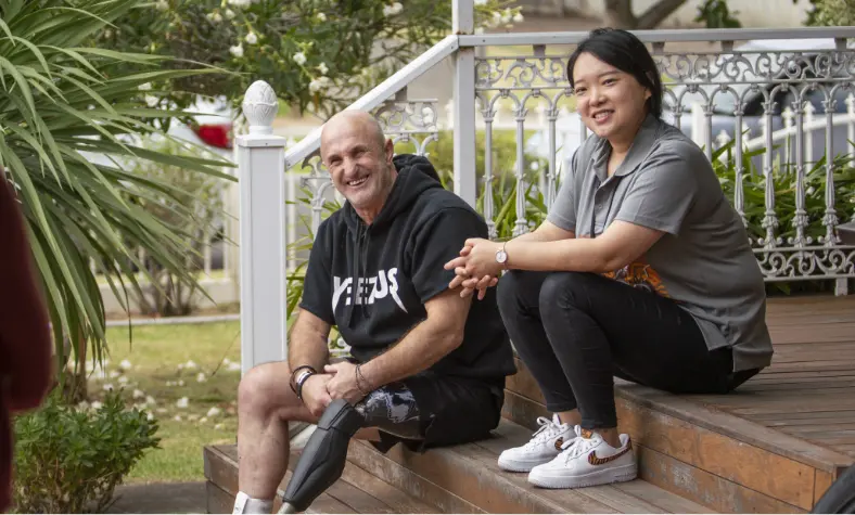 BSL NDIS participant and their support worker enjoying a break after a workout