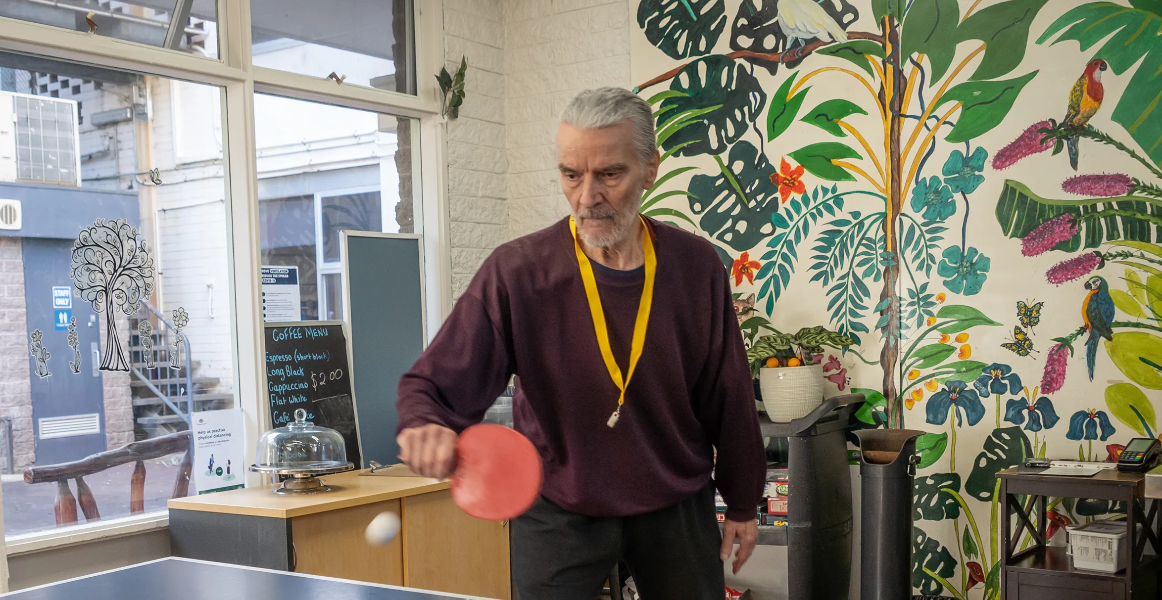 Jurgen Rogowsky, playing ping pong and about to hit the ball at the BSL Coolibah Centre.