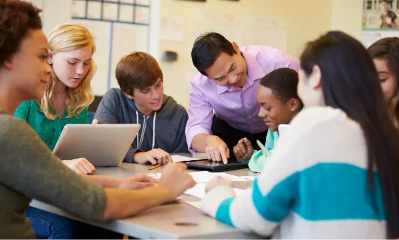 A group of young people sitting around a table participating in activities