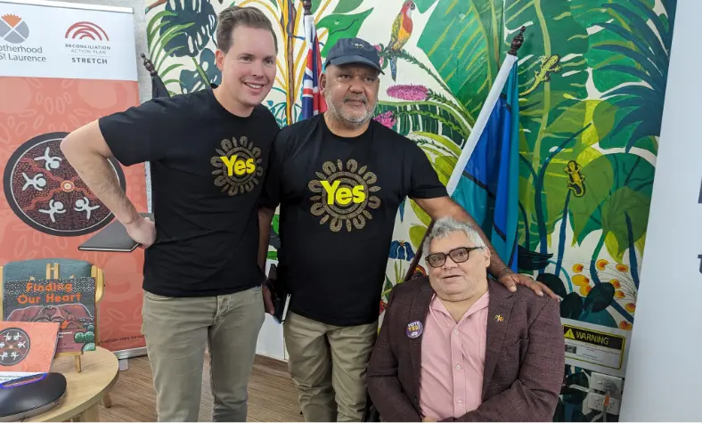 BSL Executive Director Travis McLeod with another person, both are wearing YES campaign Tshirts